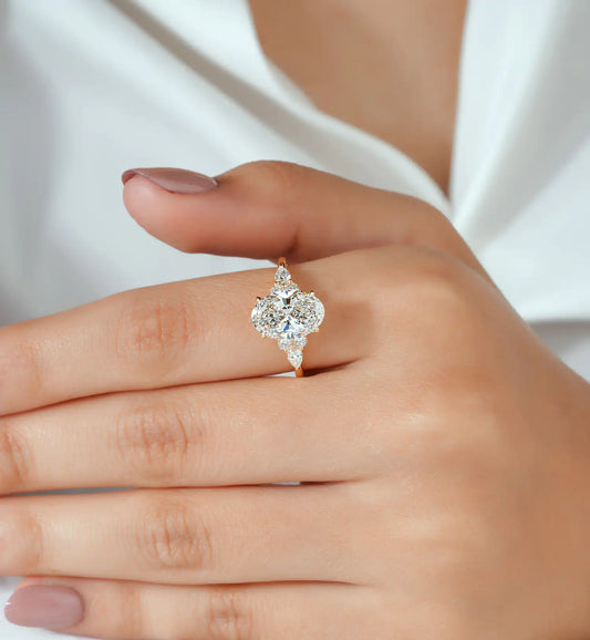 Oval Cut Diamond Ring with Pear and Round Cluster Sides