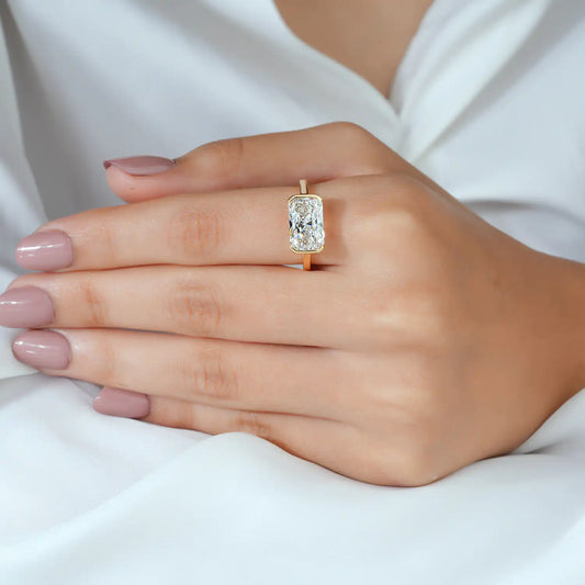 East-West Radiant Cut Bezel Set Lab Grown Diamond Solitaire Engagement Ring in Yellow Gold