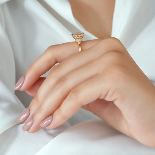 Oval Cut Diamond Ring with Pear and Round Cluster Sides
