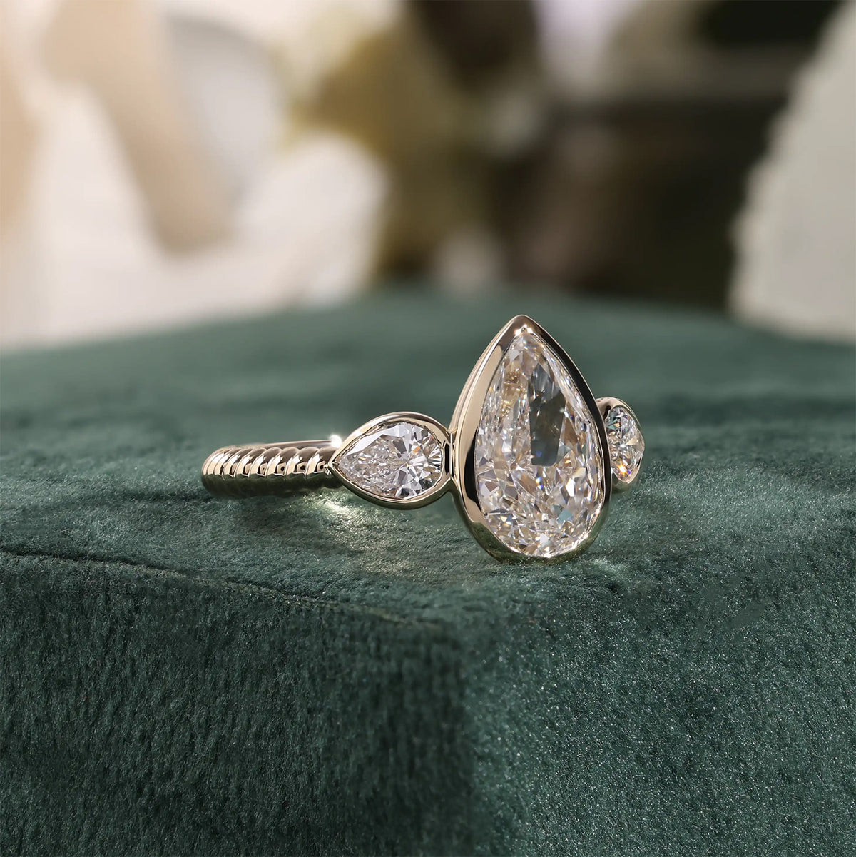Three-Stone Pear Lab Grown Diamond Bezel Engagement Ring with Ribbed Band