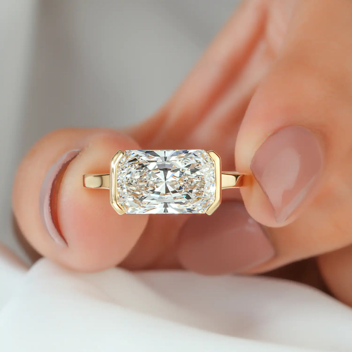 East-West Radiant Cut Bezel Set Lab Grown Diamond Solitaire Engagement Ring in Yellow Gold
