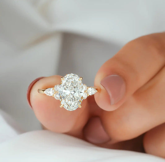 Oval Cut Diamond Ring with Pear and Round Cluster Sides