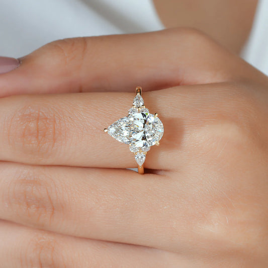 Pear Cut Lab Grown Diamond Engagement Ring with Round and Pear Cluster Accents