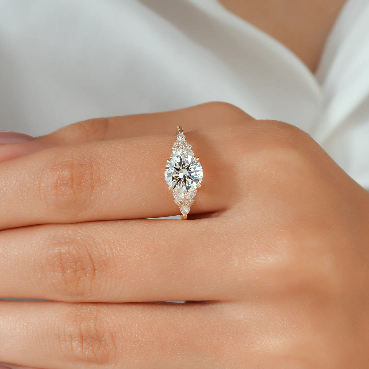 Round Lab Grown Diamond Four Prong Engagement Ring with Pear and Round Cluster Shoulders in Gold or Platinum