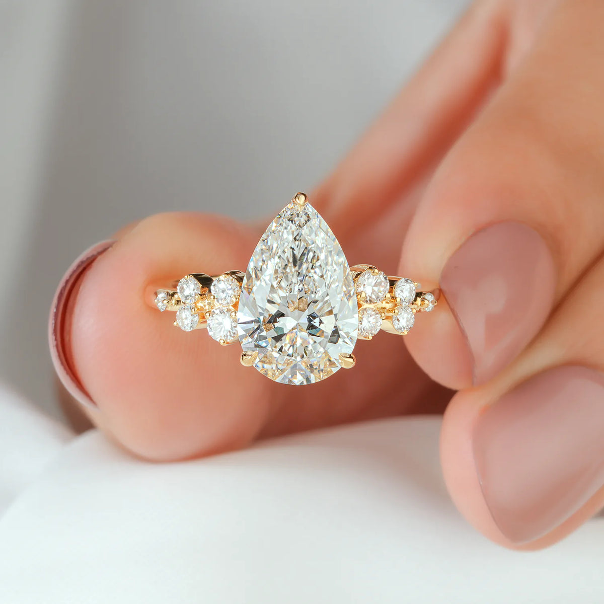 Pear Cut Lab Grown Diamond Engagement Ring with Graduated Round Cluster Shoulders