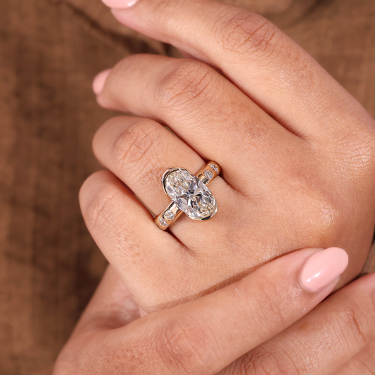 Bezel Set Oval Diamond Ring with Scattered Ring and Hidden Accent